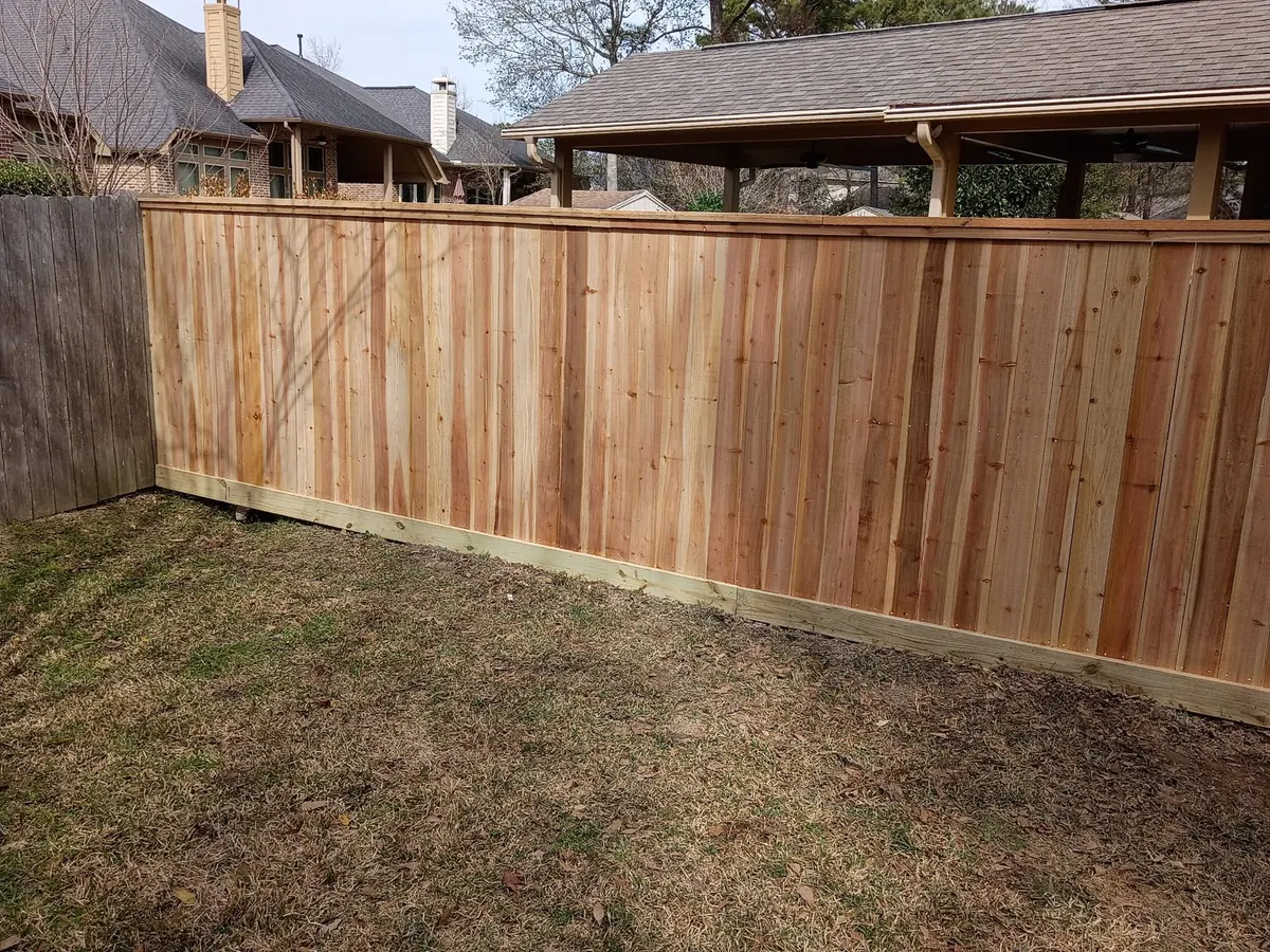 Cedar privacy fence with a gate around a backyard in north Houston