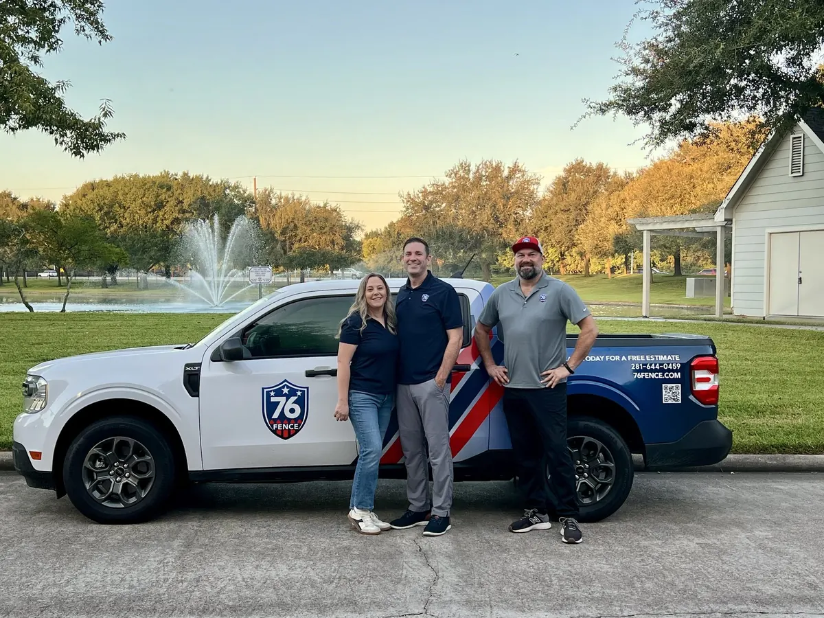 Three members of the 76 Fence West Houston team standing beside a 76 Fence work truck
