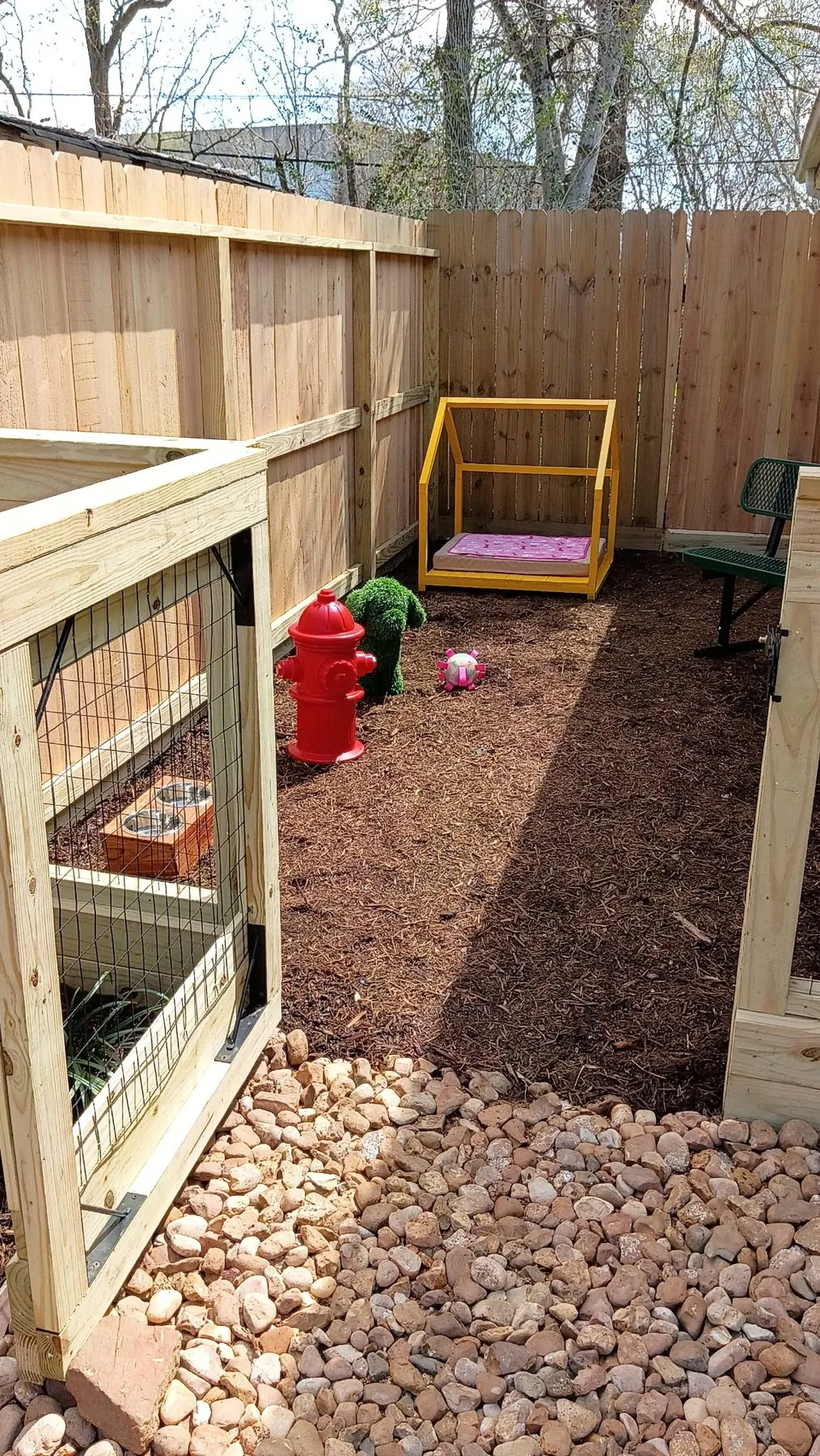 Cedar fence enclosing a side-yard dog run