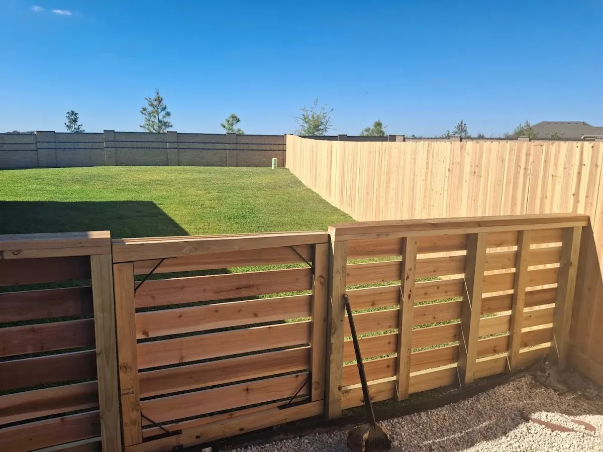 Horizontal slat gate and fence beside a cedar privacy fence