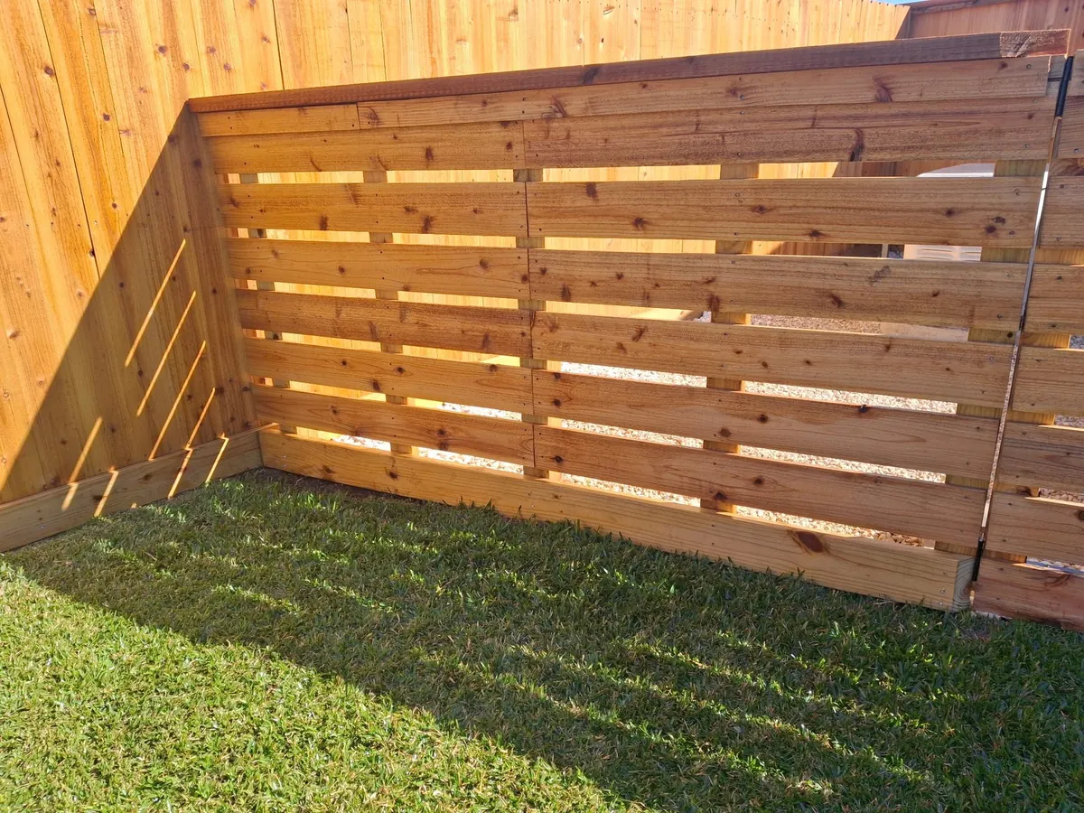Horizontal slat cedar fence in a backyard in Beasley